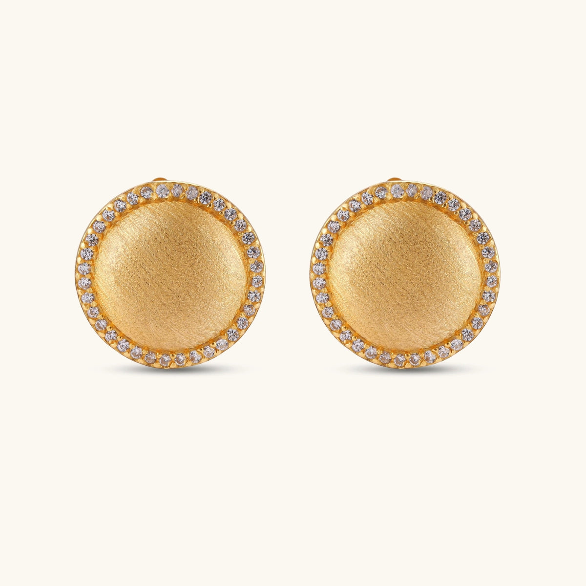 Pair of round dome stud earrings in brushed 18K gold-plated silver with a sparkling CZ halo border, push-back closure.